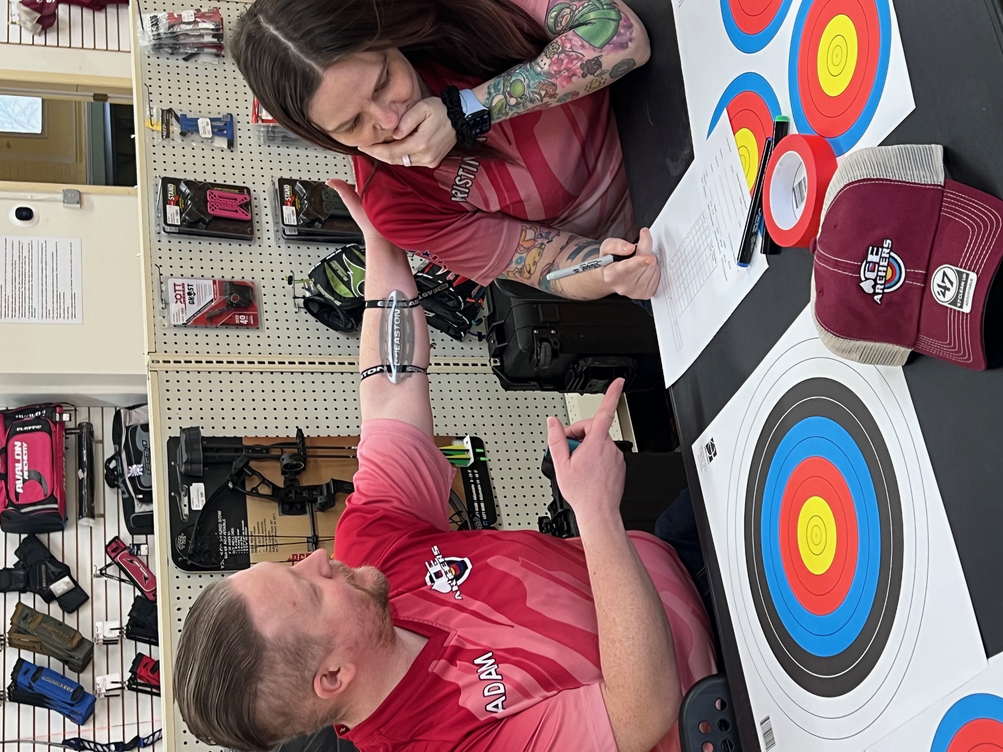 Archers reviewing scores at archery range